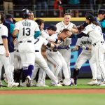 SEATTLE, WASHINGTON - JUNE 11: Dylan Moore #25 of the Seattle Mariners (center) celebrates with teammates after hitting a walk-off RBI single during the ninth inning to defeat the Boston Red Sox by a score of 7-6 at T-Mobile Park on June 11, 2022 in Seattle, Washington. (Photo by Abbie Parr/Getty Images)