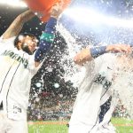SEATTLE, WASHINGTON - JUNE 11: Dylan Moore #25 of the Seattle Mariners is doused with water by J.P. Crawford #3 after hitting a walk-off RBI single during the ninth inning to defeat the Boston Red Sox by a score of 7-6 at T-Mobile Park on June 11, 2022 in Seattle, Washington. (Photo by Abbie Parr/Getty Images)