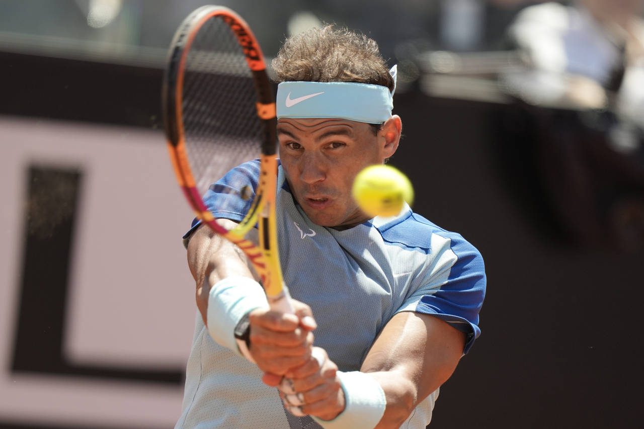 Rafael Nadal returns the ball to John Isner during their match at the Italian Open tennis tournamen...