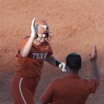 
              Texas' Courtney Day, left, celebrates after hitting home run during the second inning of an NCAA softball Women's College World Series game against Oklahoma State on Monday, June 6, 2022, in Oklahoma City. (AP Photo/Alonzo Adams)
            
