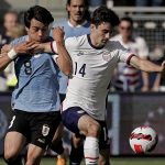
              Uruguay forward Facundo Pellistri (8) and USA midfielder Luca de la Torre (14) chase the ball during the second half of an international friendly soccer match Sunday, June 5, 2022, in Kansas City, Kan. The match ended in a 0-0 tie. (AP Photo/Charlie Riedel)
            