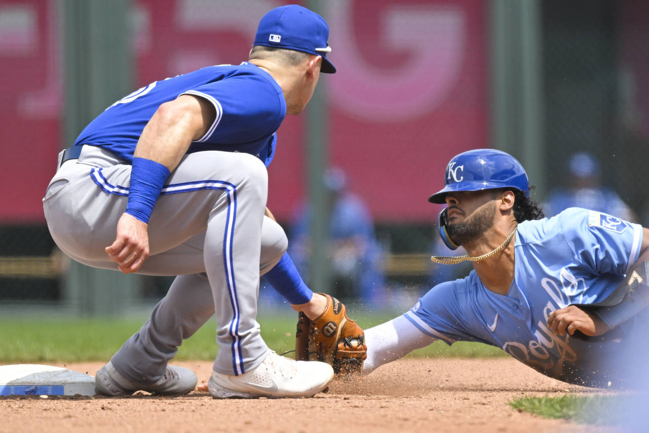 Kansas City Royals' Emmanuel Rivera, right, is caught stealing second base by Toronto Blue Jays thi...