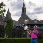 
              Rory McIlroy, of Northern Ireland, hoists the trophy after winning the Canadian Open golf tournament in Toronto on Sunday, June 12, 2022. (Frank Gunn/The Canadian Press via AP)
            