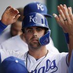 
              Kansas City Royals' Whit Merrifield celebrates in the dugout after scoring from third off a hit by Andrew Benintendi during the first inning of a baseball game against the Texas Rangers in Kansas City, Mo., Monday, June 27, 2022. (AP Photo/Colin E. Braley)
            