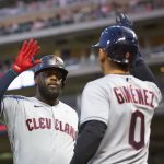 
              Cleveland Guardians' Franmil Reyes, left, is congratulated by Guardians' Andres Gimenez (0) after hitting a two-run homer against the Minnesota Twins in the eighth inning of a baseball game Tuesday, June 21, 2022, in Minneapolis. (AP Photo/Andy Clayton-King)
            