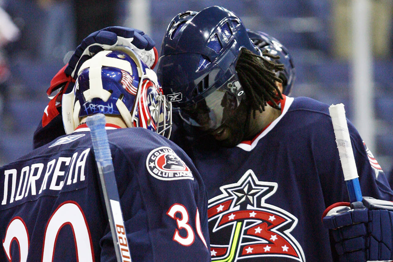 FILE - Columbus Blue Jackets' Anson Carter, right, celebrates with goalie Frederik Norrena after a ...