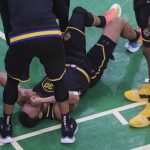 
              Golden State Warriors' Stephen Curry grimaces after Boston Celtics' Al Horford fell onto his left leg during the fourth quarter of Game 3 of basketball's NBA Finals, Wednesday, June 8, 2022, in Boston. (Carlos Avila Gonzalez/San Francisco Chronicle via AP)
            