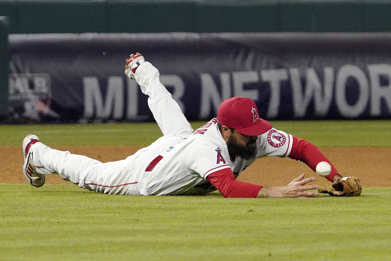 Los Angeles Angels third baseman Anthony Rendon dives for a ball that was hit for a single by New Y...