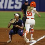 
              Arizona first baseman Carlie Scupin, left, makes a catch for an out against Oklahoma State's Chelsea Alexander (55) before  Alexander crosses first in the first inning of an NCAA softball Women's College World Series game on Thursday, June 2, 2022, in Oklahoma City. (AP Photo/Alonzo Adams)
            