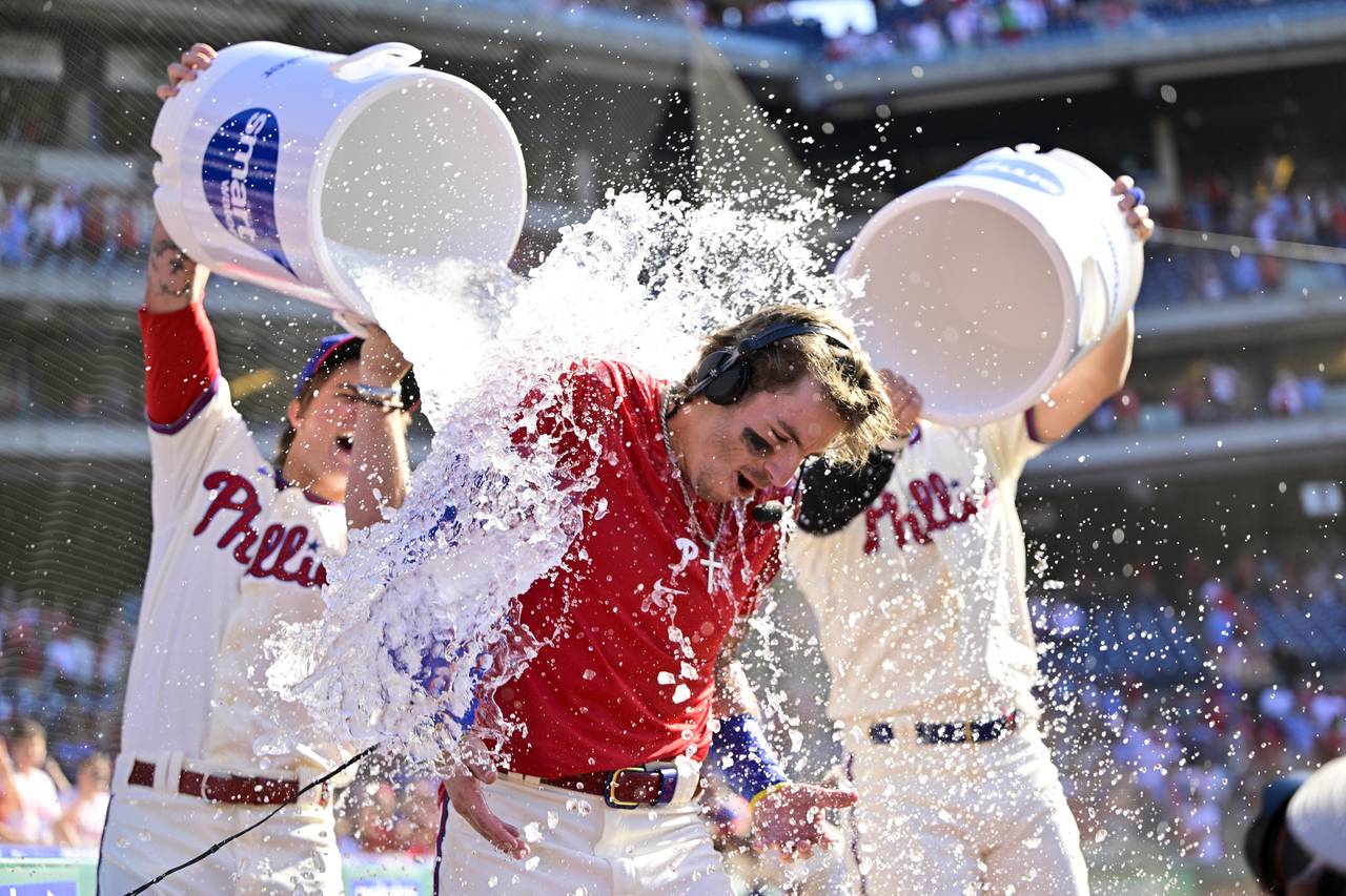 Philadelphia Phillies' Bryson Stott is doused by teammates after hitting a walk-off three run home ...