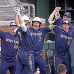 
              Notre Dame's John Michael Bertrand (28), Jack Zyska (7) and Brady Gumpf (21) celebrate after a home run by Jack Brannigan (9) against Tennessee in the fourth inning during an NCAA college baseball super regional game Friday, June 10, 2022, in Knoxville, Tenn. (AP Photo/Randy Sartin)
            