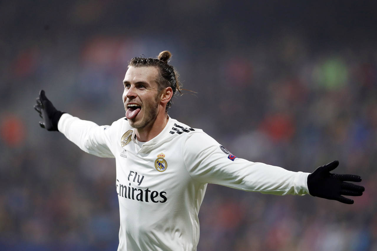 FILE - Real Madrid midfielder Gareth Bale celebrates after scoring his side's fourth goal during th...