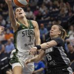 Seattle Storm's Stephanie Talbot (7) is fouled by Minnesota Lynx's Rachel Banham (15) during the first quarter of a WNBA basketball game Tuesday, June 14, 2022, in Minneapolis. (Carlos Gonzalez/Star Tribune via AP)