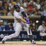
              Colorado Rockies' Elias Diaz hits an RBI single against the San Diego Padres during the third inning of the second game of a baseball doubleheader Saturday, June 11, 2022, in San Diego. (AP Photo/Mike McGinnis)
            