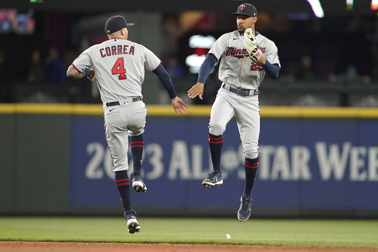 Minnesota Twins' Carlos Correa (4) and Byron Buxton celebrate after the team's 5-0 win in a basebal...