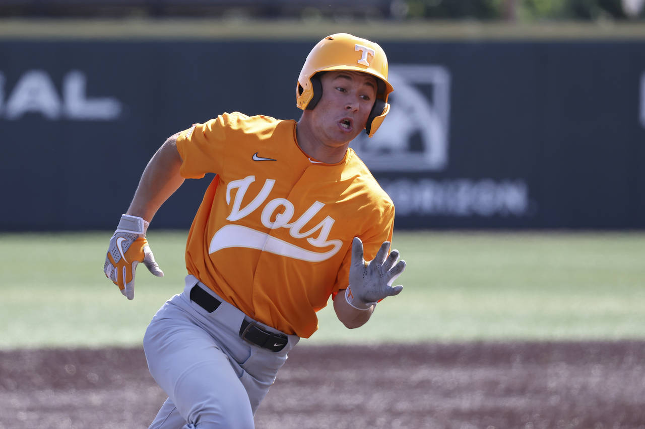 Tennessee's Seth Stephenson rounds third base as he scores on a double by Jorel Ortega in the seven...