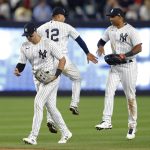 
              New York Yankees right fielder Joey Gallo left, shortstop Isiah Kiner-Falefa, center, and left fielder Aaron Hicks celebrate after defeating the Oakland Athletics 2-1 in a baseball game Tuesday, June 28, 2022, in New York. (AP Photo/Noah K. Murray)
            