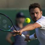 
              Switzerland's Stan Wawrinka returns the ball to Italy's Jannik Sinner during their men's singles match on day one of the Wimbledon tennis championships in London, Monday, June 27, 2022. (AP Photo/Alastair Grant)
            