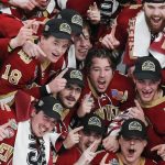 
              FILE - Denver players pose for a team photo after defeating Minnesota State in the NCAA men's Frozen Four championship college hockey game April 9, 2022, in Boston. The Mile High City is now home to the Stanley Cup, NCAA and national high school hockey champions. (AP Photo/Michael Dwyer, File)
            