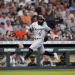 
              Chicago White Sox's Josh Harrison runs down the third base line to score during the fourth inning of a baseball game against the Houston Astros Saturday, June 18, 2022, in Houston. (AP Photo/David J. Phillip)
            