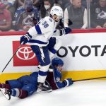 
              Tampa Bay Lightning defenseman Mikhail Sergachev (98) steps over Colorado Avalanche right wing Mikko Rantanen (96) during the second period in Game 2 of the NHL hockey Stanley Cup Final on Saturday, June 18, 2022, in Denver. (AP Photo/David Zalubowski)
            