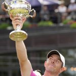 
              Rory McIlroy, of Northern Ireland, raises the trophy after winning the final round of the Canadian Open golf tournament in Toronto, Sunday, June 12, 2022. (Frank Gunn/The Canadian Press via AP)
            