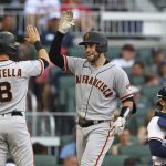 
              San Francisco Giants catcher Austin Wynns (right) gets a fiver from Tommy La Stella after hitting a 3-run homer against Braves starting pitcher Spencer Strider to take a 4-0 lead during the second inning of a baseball game on Tuesday, June 21, 2022, in Atlanta. (Curtis Compton Atlanta Journal-Constitution via AP)
            