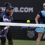 
              Serena Williams of the United States, left, returns the ball as Ons Jabeur of Tunisia looks on during their doubles tennis match against Marie Bouzkova of Czech Republic and Sara Sorribes Tormo of Spain at the Eastbourne International tennis tournament in Eastbourne, England, Tuesday, June 21, 2022. (AP Photo/Kirsty Wigglesworth)
            