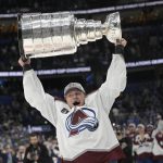 
              Colorado Avalanche defenseman Erik Johnson lifts the Stanley Cup after the team defeated the Tampa Bay Lightning in Game 6 of the NHL hockey Stanley Cup Finals on Sunday, June 26, 2022, in Tampa, Fla. (AP Photo/Phelan Ebenhack)
            