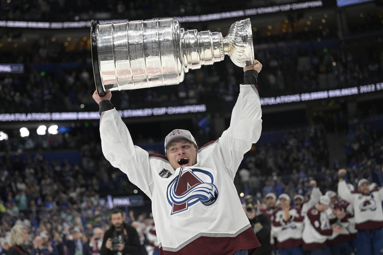 Colorado Avalanche defenseman Erik Johnson lifts the Stanley Cup after the team defeated the Tampa ...