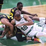 
              Golden State Warriors' Stephen Curry, left, is caught under Boston Celtics' Al Horford (42) during the fourth quarter of Game 3 of basketball's NBA Finals, Wednesday, June 8, 2022, in Boston. (Scott Strazzante/San Francisco Chronicle via AP)
            