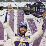 
              Chase Elliott holds the guitar presented to him after winning a NASCAR Cup Series auto race Sunday, June 26, 2022, in Lebanon, Tenn. (AP Photo/Mark Humphrey)
            