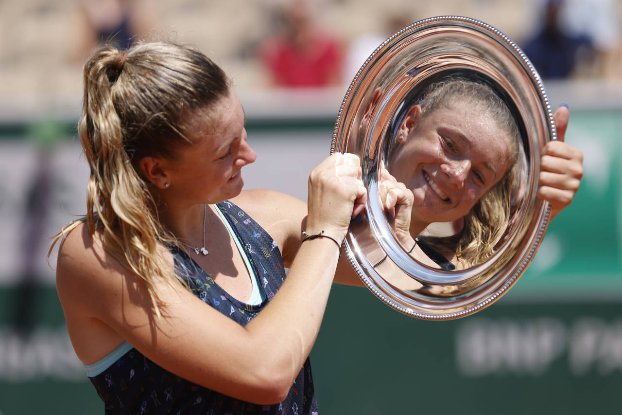 Czech Republic's Lucie Havlickova is reflected in her trophy during a ceremony after defeating Arge...