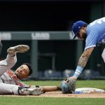 
              Baltimore Orioles' Richie Martin, left, is safe with a triple as Kansas City Royals third baseman Emmanuel Rivera, right, is late with a tag during the sixth inning of a baseball game in Kansas City, Mo., Sunday, June 12, 2022. (AP Photo/Colin E. Braley)
            