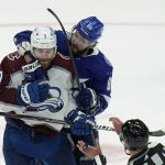 
              Tampa Bay Lightning right wing Nikita Kucherov (86) grabs Colorado Avalanche defenseman Devon Toews (7) after a cross check during the third period of Game 3 of the NHL hockey Stanley Cup Final on Monday, June 20, 2022, in Tampa, Fla. (AP Photo/Chris O'Meara)
            