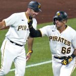 
              Pittsburgh Pirates' Bligh Madris (66) rounds third to get a high five from third base coach Mike Rabelo after hitting a solo home run off Chicago Cubs relief pitcher Mark Leiter Jr. during the sixth inning of a baseball game in Pittsburgh, Tuesday, June 21, 2022. (AP Photo/Gene J. Puskar)
            