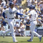 
              Los Angeles Dodgers' Freddie Freeman, left, celebrates after his solo home run with Will Smith during the third inning of a baseball game against the Cleveland Guardians in Los Angeles, Sunday, June 19, 2022. (AP Photo/Kyusung Gong)
            