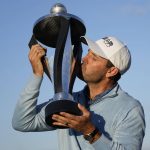 
              Charles Schwartzel of South Africa kisses the trophy as he poses for the media after he won the inaugural LIV Golf Invitational at the Centurion Club in St Albans, England, Saturday, June 11, 2022. (AP Photo/Alastair Grant)
            