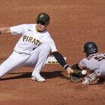 
              Pittsburgh Pirates second baseman Diego Castillo, left, cannot handle the throw from catcher Tyler Heineman (not shown) as San Francisco Giants' Luis Gonzalez (51) safely steals second base during the second inning of a baseball game in Pittsburgh, Saturday, June 18, 2022. (AP Photo/Gene J. Puskar)
            
