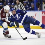 
              Colorado Avalanche center Nathan MacKinnon (29) checks Tampa Bay Lightning left wing Ondrej Palat (18) during the first period of Game 6 of the NHL hockey Stanley Cup Finals on Sunday, June 26, 2022, in Tampa, Fla. (AP Photo/Phelan Ebenhack)
            