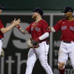 
              Boston Red Sox's Trevor Story, left, Alex Verdugo, center, and Xander Bogaerts celebrate the team's win over the Oakland Athletics in a baseball game at Fenway Park, Wednesday, June 15, 2022, in Boston. (AP Photo/Mary Schwalm)
            