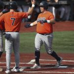 
              Auburn infielder Sonny DiChiara, right, celebrates with Cole Foster, center, and Bobby Peirce, left, after hitting a two-run home run during the third inning of an NCAA college baseball tournament super regional game against Oregon State on Monday, June 13, 2022, in Corvallis, Ore. (AP Photo/Amanda Loman)
            