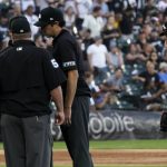 
              Chicago White Sox starting pitcher Michael Kopech, right, wipes face while umpires confer during the second inning of the team's baseball game against the Baltimore Orioles in Chicago, Friday, June 24, 2022. (AP Photo/Nam Y. Huh)
            