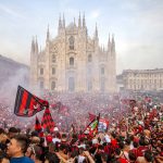 
              AC Milan fans celebrate in Piazza Duomo square after a Serie A soccer match between Sassuolo and AC Milan, being played in Reggio Emilia, in Milan, Italy, Sunday, May 22, 2022. AC Milan secured its first Serie A title in 11 years on Sunday with a 3-0 win at Sassuolo. (LaPresse via AP)
            