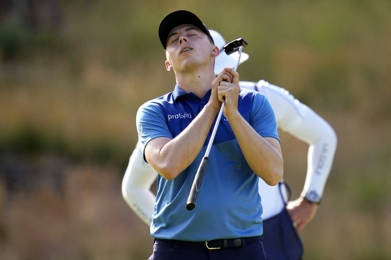 Matthew Fitzpatrick, of England, reacts after putting on the 13th hole during the first round of th...