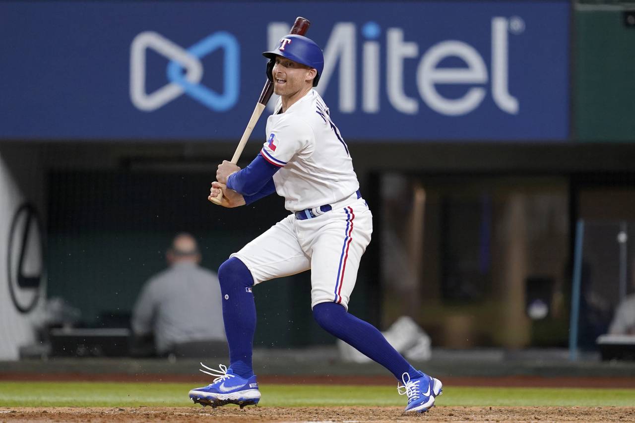 Texas Rangers' Brad Miller follows through on a run-scoring single in the eighth inning of a baseba...