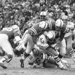 
              FILE - Dallas Cowboys' Don Perkins is taken down by Baltimore Colts' Billy Ray Smith (74) and Ordell Braase (81) during a football game in Baltimore on Dec. 3, 1967. Perkins, a six-time Pro Bowl running back with the Cowboys in the 1960s, has died. He was 84. The NFL team and the University of New Mexico, where Perkins was a standout player before his professional career, said Perkins died Thursday, June 9, 2022. No cause of death was revealed. (AP Photo, File)
            