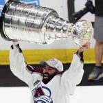
              CORRECTS ID TO NAZEM KADRI INSTEAD OF NATHAN MACKINNON - Colorado Avalanche center Nazem Kadri lifts the Stanley Cup after the team defeated the Tampa Bay Lightning 2-1 in Game 6 of the NHL hockey Stanley Cup Finals on Sunday, June 26, 2022, in Tampa, Fla. (AP Photo/John Bazemore)
            