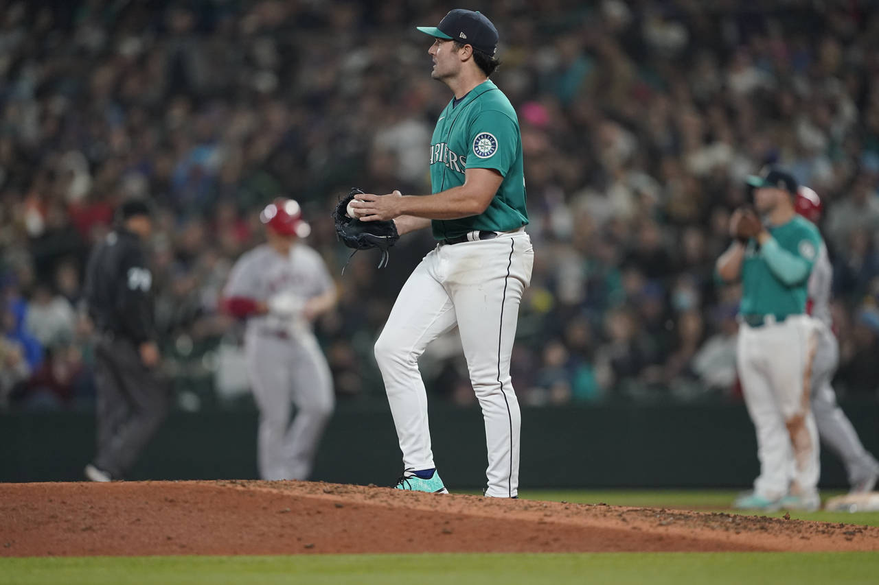 Seattle Mariners starting pitcher Robbie Ray stands on the mound after he gave up a single to Los A...