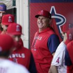 
              Los Angeles Angels interim manager Phil Nevin, center, smiles in the dugout before a baseball game against the Boston Red Sox in Anaheim, Calif., Tuesday, June 7, 2022. (AP Photo/Ashley Landis)
            